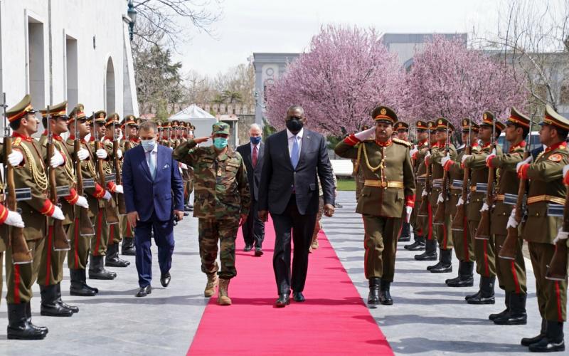 El secretario estadunidense de Defensa, Lloyd Austin (c), con su colega afgano en funciones, el ministro afgano en funciones, Yasin Zia, pasan revista a una guardia de honor en el Palacio Presidencial de Kabul, el 21 de marzo de 2021