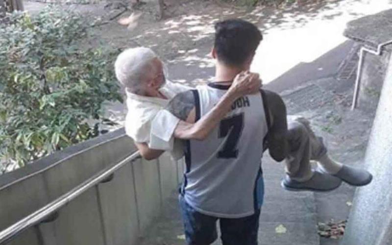 Joven lleva cargando a su abuelo para recibir vacuna covid;