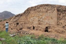 Un arqueólogo inspecciona el antiguo mural prehispánico descubierto en un campo agrícola al norte de Lima.
